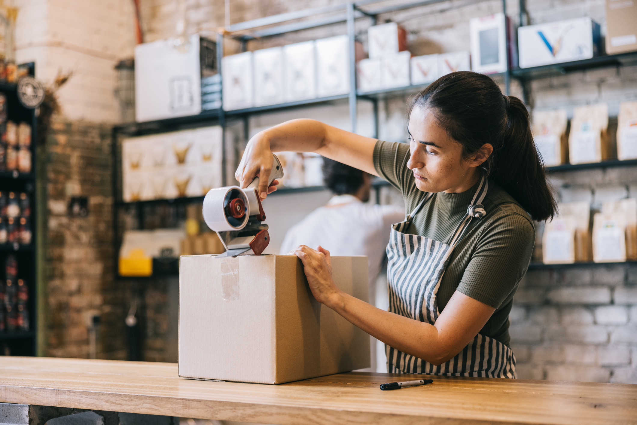 A woman packing up some items ready to be shipped