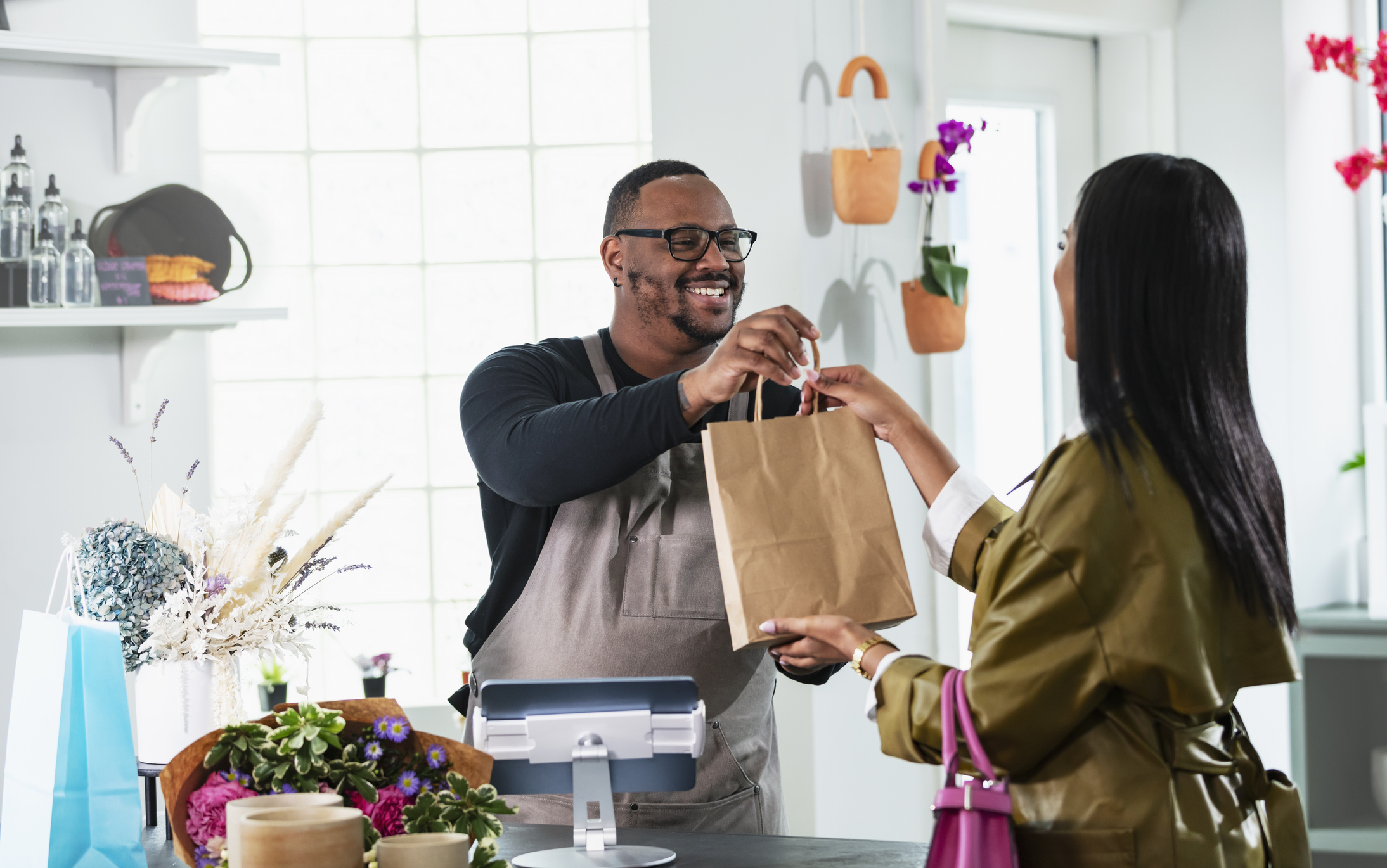 A man putting a purchase in a bag