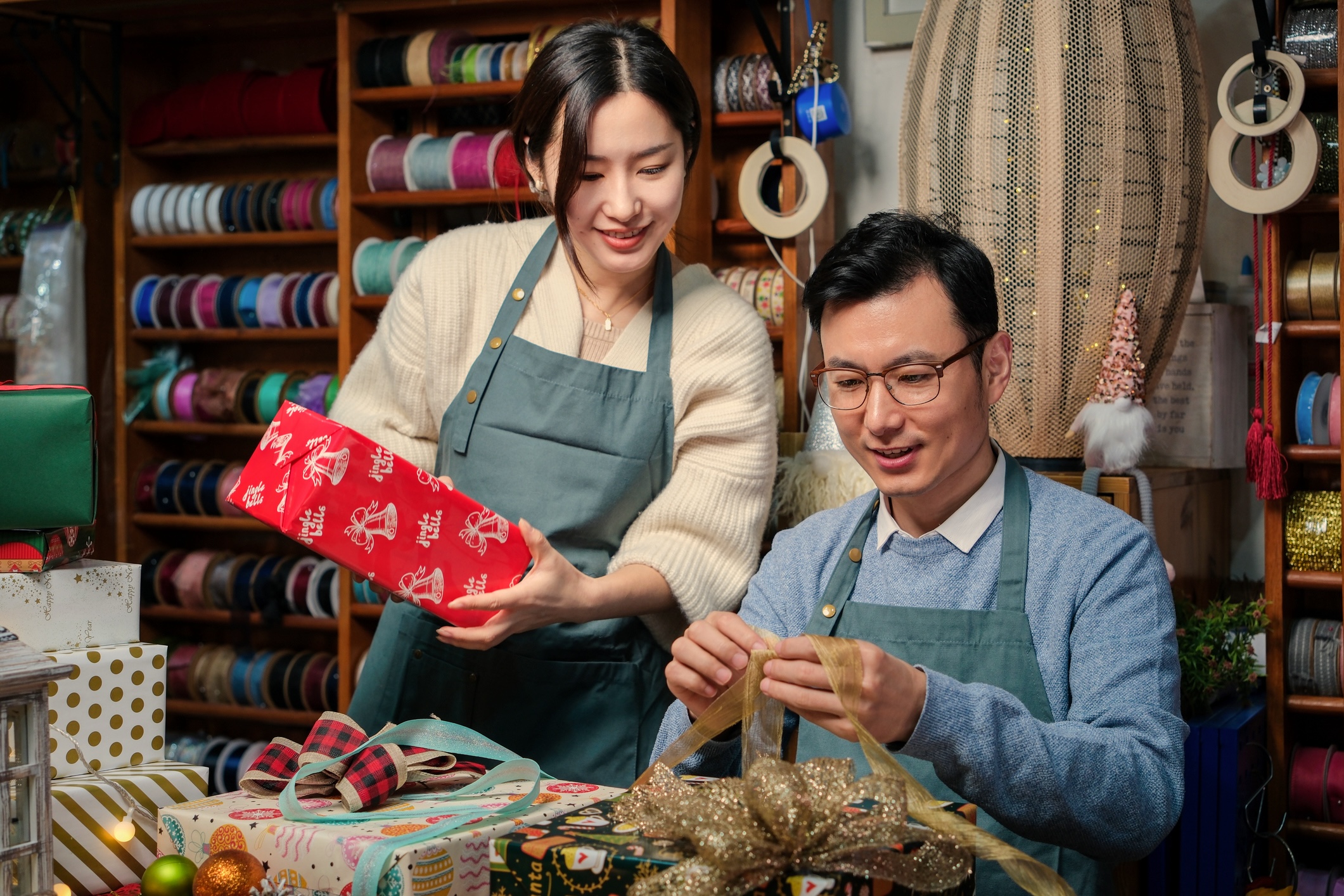 Two people wrapping purchases