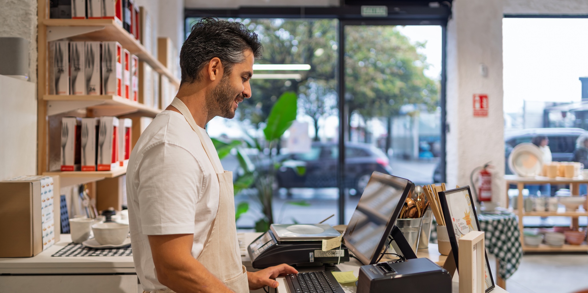 A man checking out a customer at a store